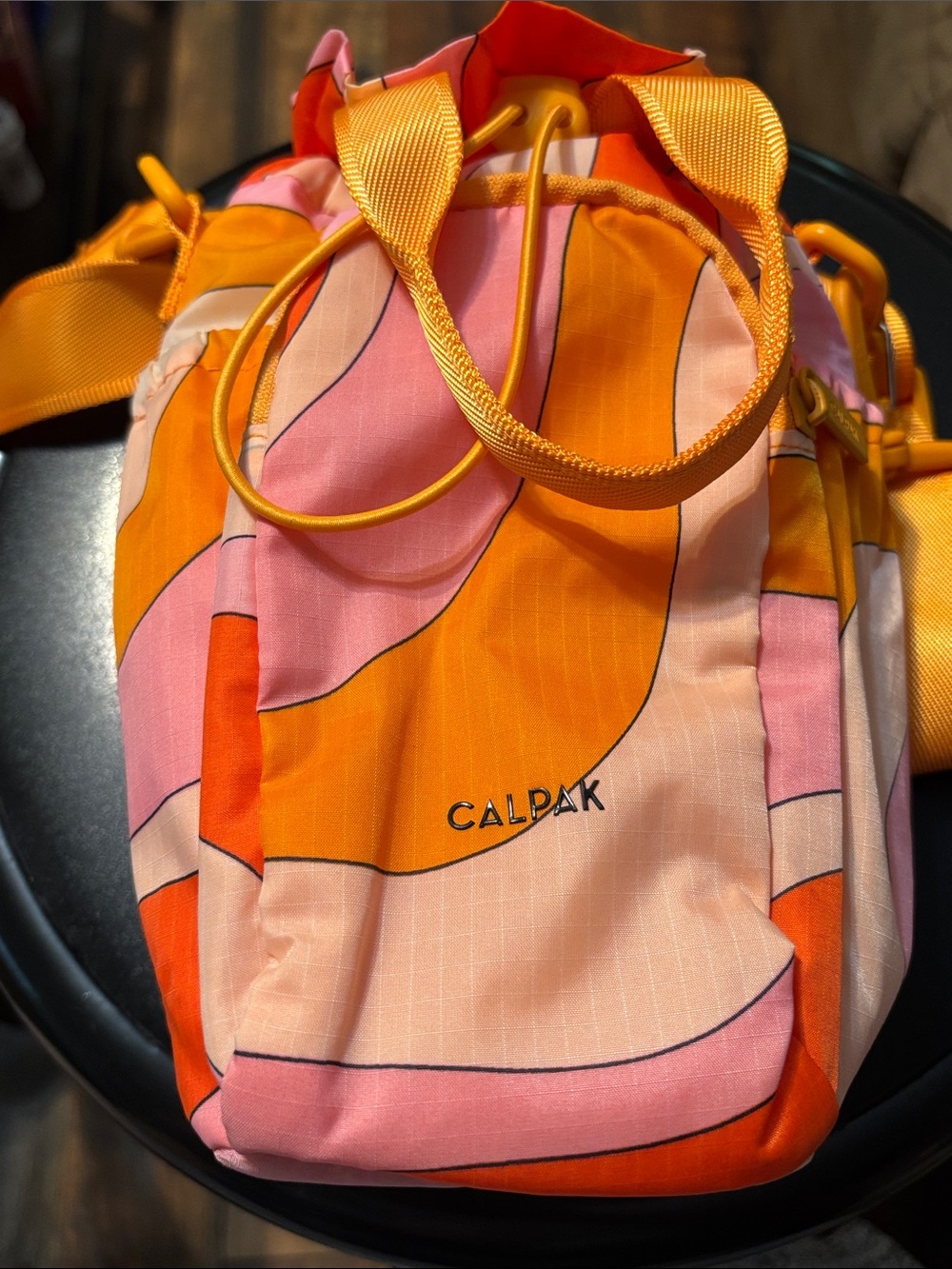 Calpak Pink and Orange water bottle holder crossbody sling in retro sunset